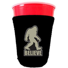 Load image into Gallery viewer, black party cup koozie with bigfoot believe design