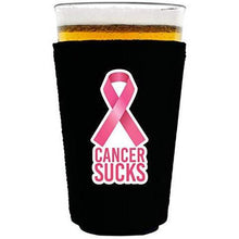 Load image into Gallery viewer, black pint glass koozie with cancer sucks text and pink ribbon graphic