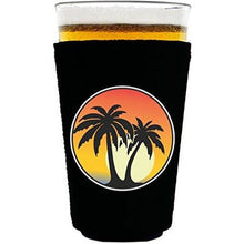 Load image into Gallery viewer, pint glass koozie with palm tree sunset design