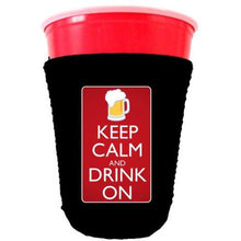 Load image into Gallery viewer, black party cup koozie with keep calm and drink on design 
