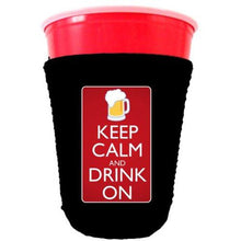 Load image into Gallery viewer, black party cup koozie with keep calm and drink on design