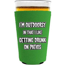 Load image into Gallery viewer, I'm Outdoorsy in that I Like Getting Drunk on Patios Pint Glass Koozie