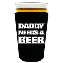 Load image into Gallery viewer, black pint glass koozie with daddy needs a beer design text
