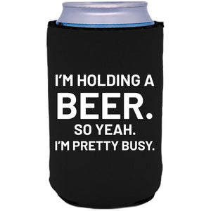 12oz. collapsible neoprene can koozie with "I'm holding a beer.." graphic printed on one side.
