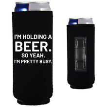 Load image into Gallery viewer, 12oz. collapsible, neoprene slim can koozie with strong magnets sewn into one side; &quot;I&#39;m holding a beer,,,&quot; graphic printed on the opposite side.
