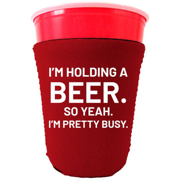 https://cooliejunction.com/cdn/shop/files/holding-a-beer-busy-solo-cup-koozie-red.jpg?v=1685390642&width=360
