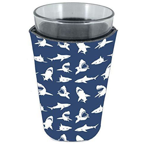 pint glass koozie with shark silhouettes in white on a navy background