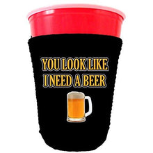 Load image into Gallery viewer, black party cup koozie with you look like i need a beer design 
