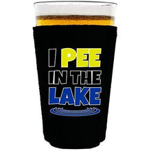 Load image into Gallery viewer, black pint glass koozie with “I pee in the lake” funny text design
