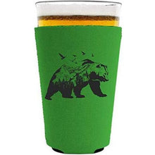 Load image into Gallery viewer, bright green pint glass koozie with mountain bear graphic design
