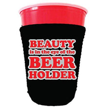 Load image into Gallery viewer, black party cup koozie with beauty is in the eye of the beer holder design 
